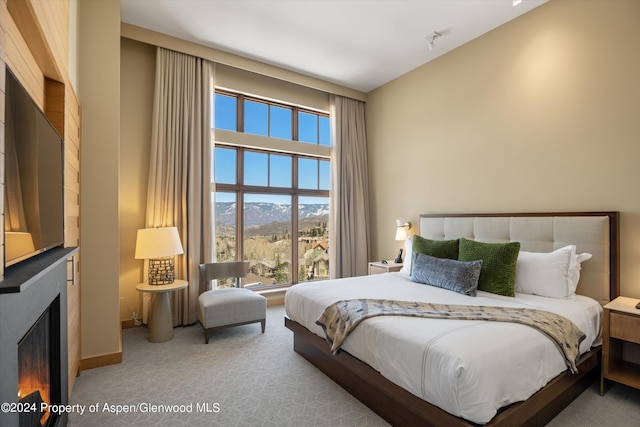 bedroom with carpet flooring and a mountain view