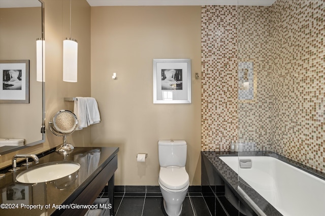 bathroom featuring toilet, tile patterned floors, a bathing tub, and sink