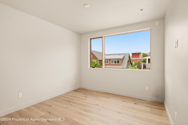 unfurnished room featuring light wood-type flooring