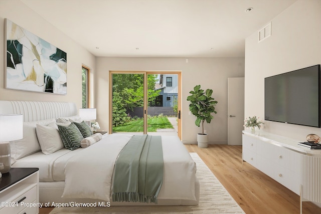 bedroom featuring light hardwood / wood-style floors and access to outside