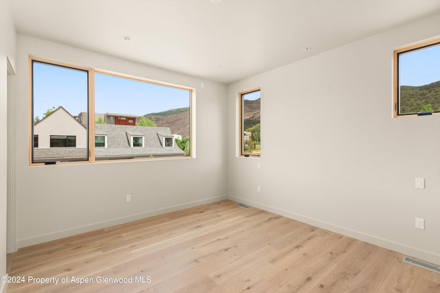 spare room with light wood-type flooring