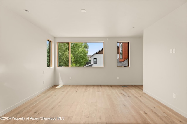 spare room with light hardwood / wood-style flooring