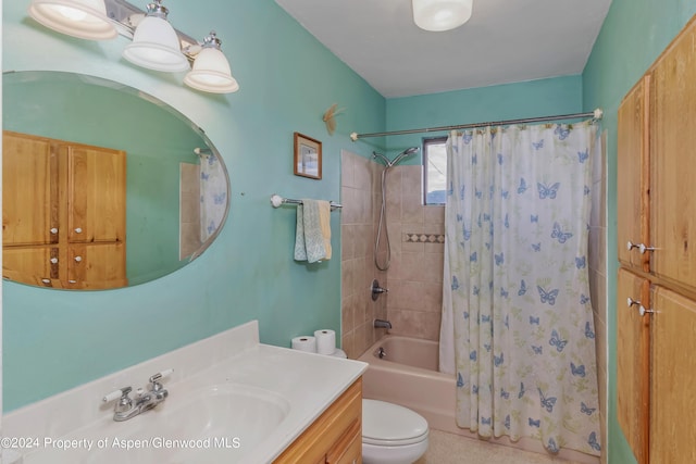 full bathroom with vanity, shower / tub combo, and toilet