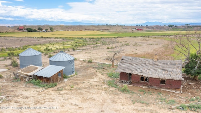 birds eye view of property with a mountain view and a rural view