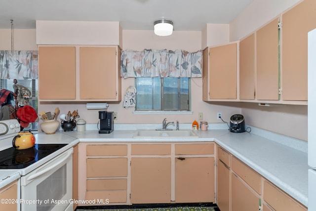 kitchen featuring white range with electric stovetop, sink, and light brown cabinets