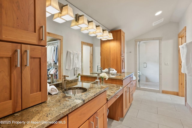 554 Sinclair Rd, Snowmass Village, CO 81615 - bathroom featuring a stall shower, tile patterned floors, vaulted ceiling, vanity, and a walk in closet