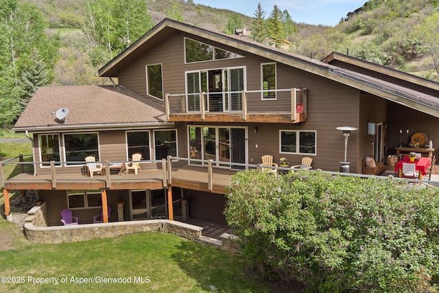 554 Sinclair Rd, Snowmass Village, CO 81615 - rear view of property featuring a balcony, a lawn, and a deck with mountain view