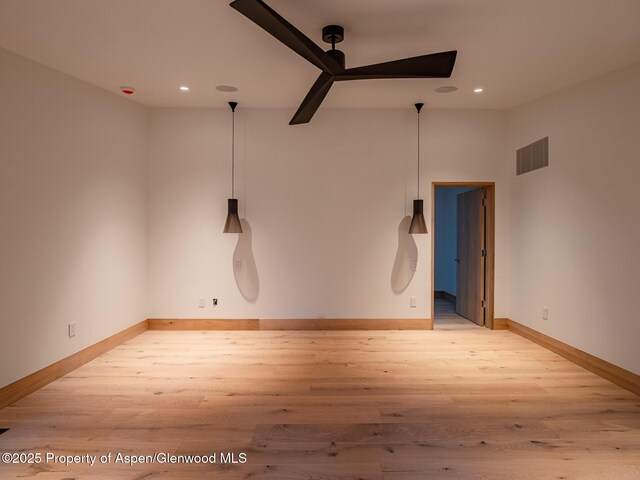 empty room featuring ceiling fan, recessed lighting, baseboards, light wood-type flooring, and visible vents