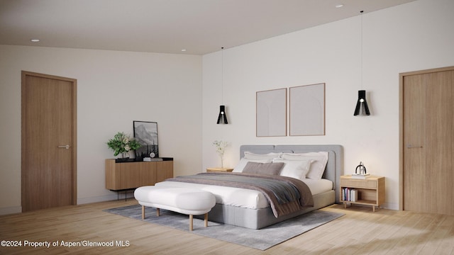 bedroom with wood-type flooring and vaulted ceiling