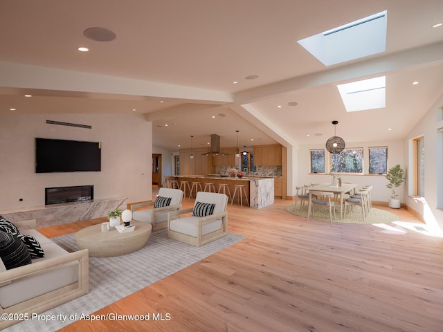 51 Roaring Fork Dr, Aspen, CO 81611 - living area with light wood-style flooring, a skylight, recessed lighting, and a high end fireplace
