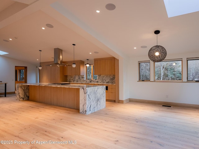 kitchen featuring tasteful backsplash, island exhaust hood, light wood-style flooring, and modern cabinets