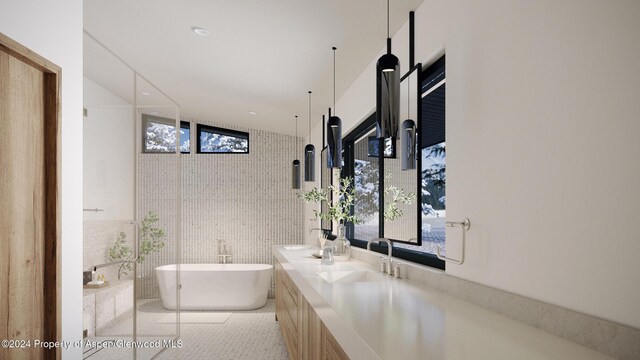 bathroom with tile patterned floors, a wealth of natural light, a bathing tub, and tile walls