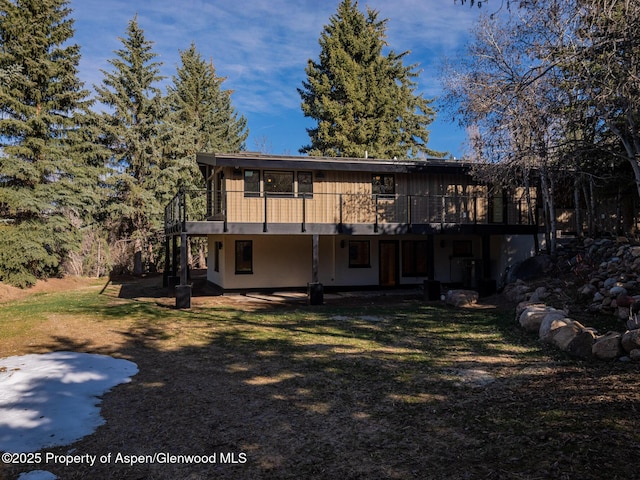 51 Roaring Fork Dr, Aspen, CO 81611 - back of property with a deck and a lawn