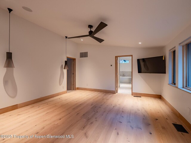 interior space featuring visible vents, light wood finished floors, ceiling fan, and baseboards