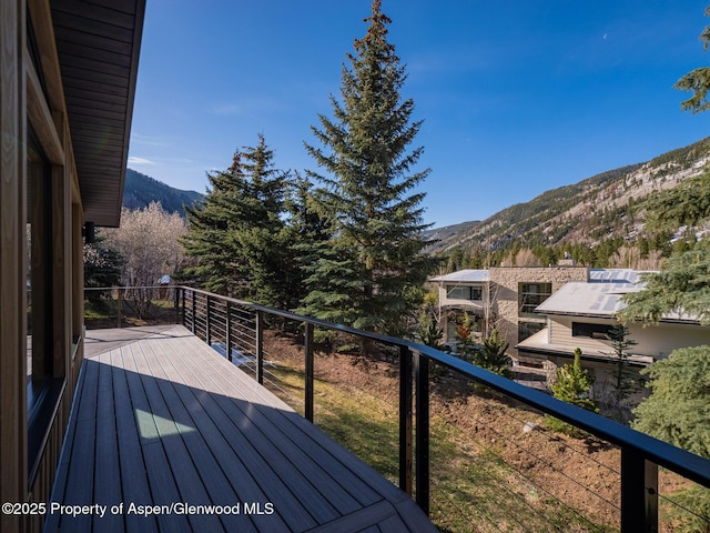 wooden deck featuring a mountain view