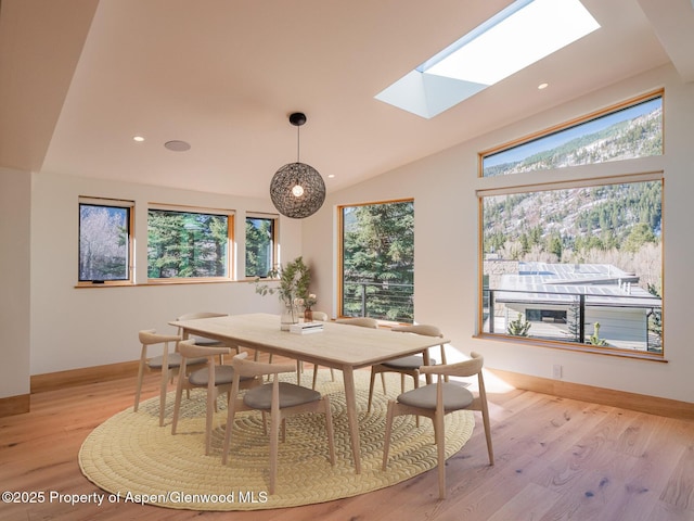 51 Roaring Fork Dr, Aspen, CO 81611 - dining area featuring a skylight, light wood finished floors, recessed lighting, lofted ceiling, and baseboards