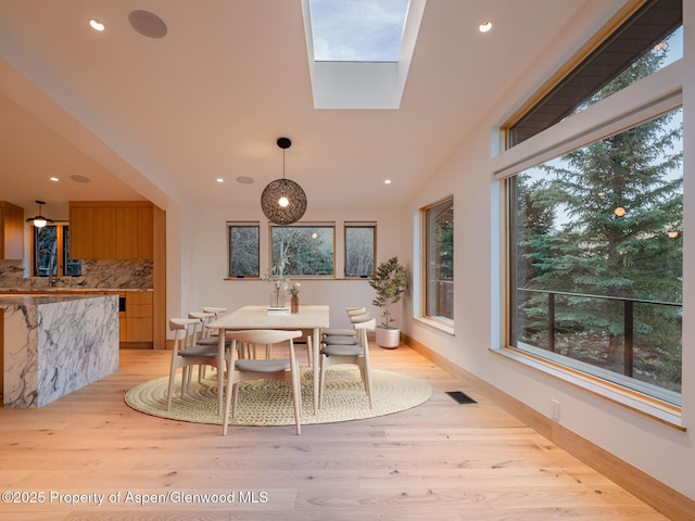 51 Roaring Fork Dr, Aspen, CO 81611 - dining space with recessed lighting, light wood-type flooring, a skylight, and baseboards