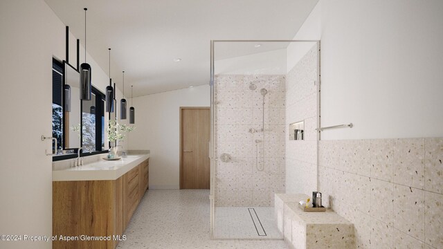 bathroom featuring vanity, walk in shower, lofted ceiling, and tile walls