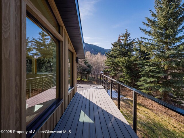 wooden deck with a mountain view