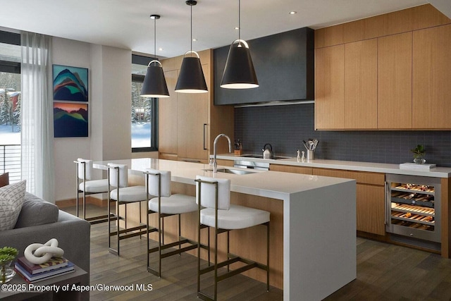 77 Wood Rd Unit 306-51, Snowmass Village, CO 81615 - kitchen with wine cooler, modern cabinets, dark wood-style flooring, decorative backsplash, and light countertops