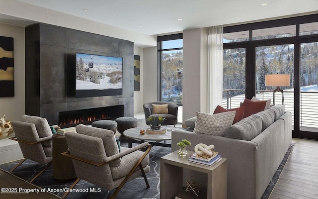 77 Wood Rd Unit 306-51, Snowmass Village, CO 81615 - living room with hardwood / wood-style flooring and a fireplace
