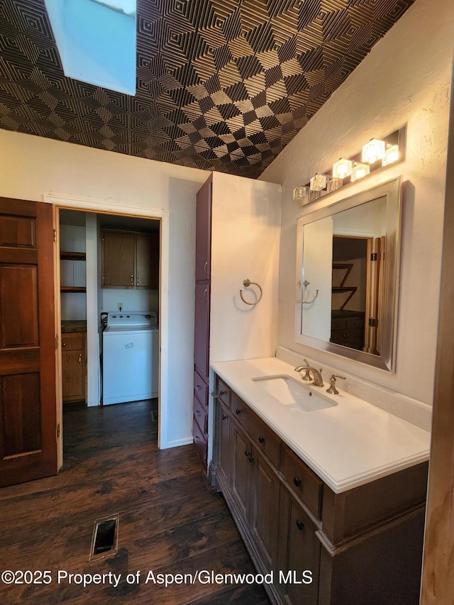 449 County Road 223, Rifle, CO 81650 - bathroom with wood finished floors, vanity, and washer / dryer