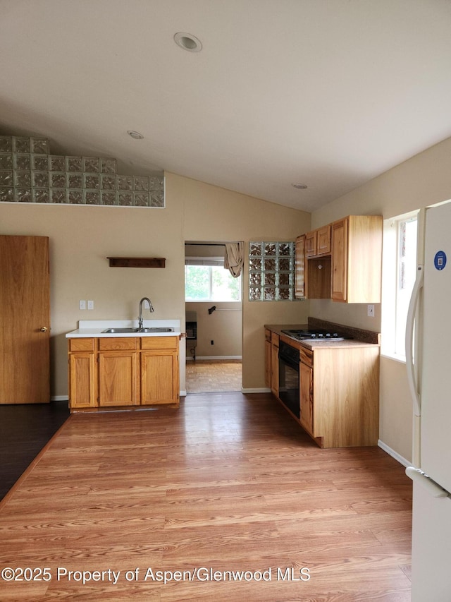 449 County Road 223, Rifle, CO 81650 - kitchen with freestanding refrigerator, a sink, lofted ceiling, light wood-type flooring, and oven