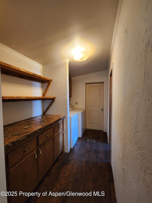 449 County Road 223, Rifle, CO 81650 - washroom featuring cabinet space, washing machine and dryer, dark wood-style floors, and a textured wall