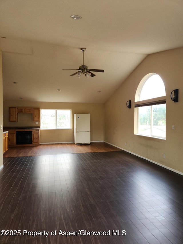 449 County Road 223, Rifle, CO 81650 - unfurnished living room with lofted ceiling, dark wood-style floors, a ceiling fan, and baseboards