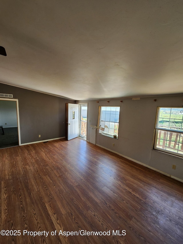449 County Road 223, Rifle, CO 81650 - empty room with dark wood-style flooring, plenty of natural light, and baseboards