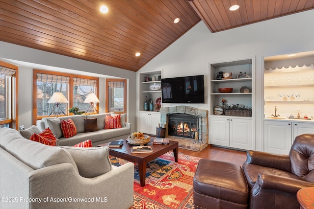 living area with a wealth of natural light, built in shelves, a fireplace, and wood ceiling