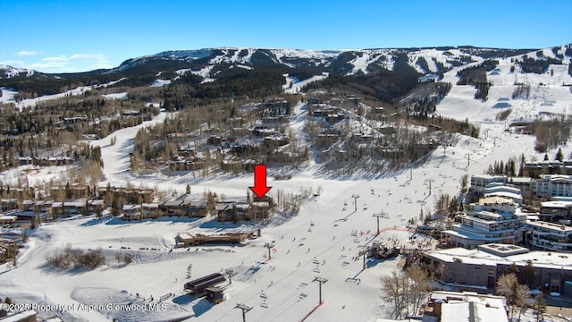 snowy aerial view featuring a mountain view