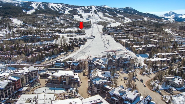 snowy aerial view featuring a mountain view