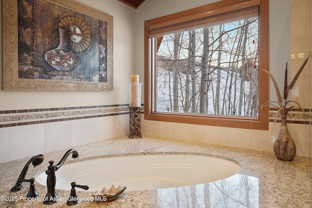 bathroom with a garden tub