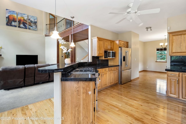 383 Faas Ranch Rd, New Castle, CO 81647 - kitchen featuring appliances with stainless steel finishes, tile countertops, light wood-type flooring, and open floor plan
