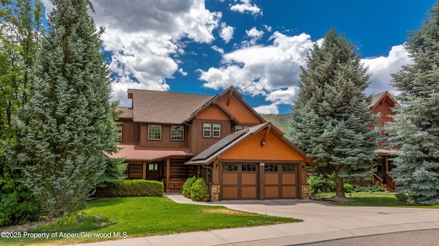 383 Faas Ranch Rd, New Castle, CO 81647 - view of front of house with stone siding, a front yard, driveway, and a garage