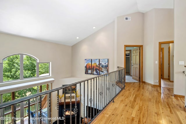 383 Faas Ranch Rd, New Castle, CO 81647 - hallway featuring healthy amount of natural light, high vaulted ceiling, and wood-type flooring
