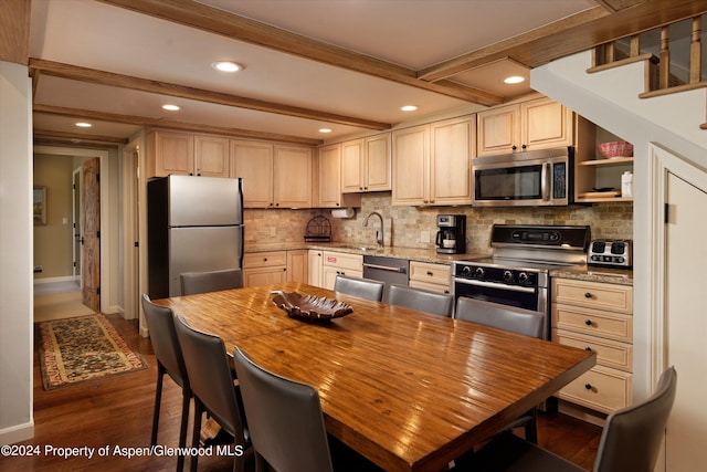 kitchen featuring decorative backsplash, stainless steel appliances, sink, beam ceiling, and dark hardwood / wood-style floors