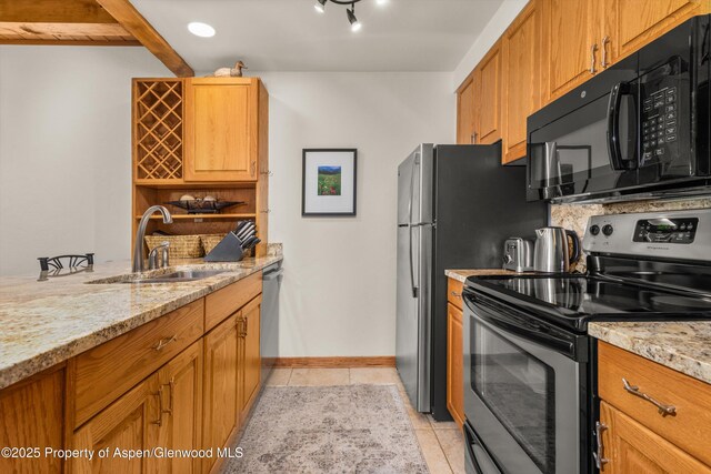 610 S W End St Unit J204, Aspen, CO 81611 - kitchen with appliances with stainless steel finishes, a sink, light tile patterned flooring, and light stone countertops