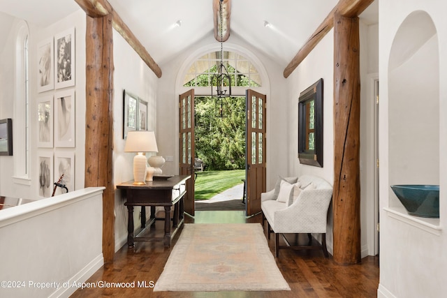 living area featuring vaulted ceiling with beams and dark hardwood / wood-style floors