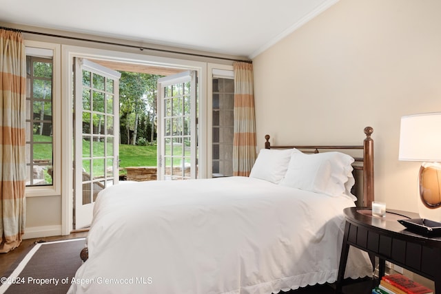 bedroom with access to exterior, crown molding, and dark hardwood / wood-style flooring