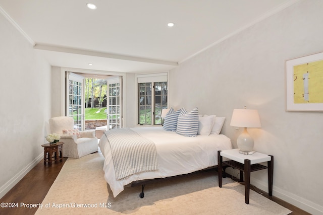 bedroom with dark hardwood / wood-style flooring and crown molding