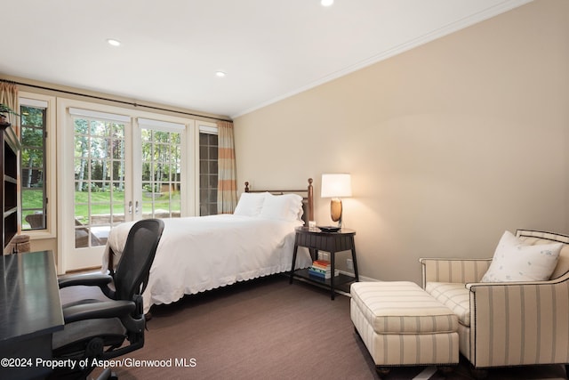 bedroom with crown molding and dark colored carpet