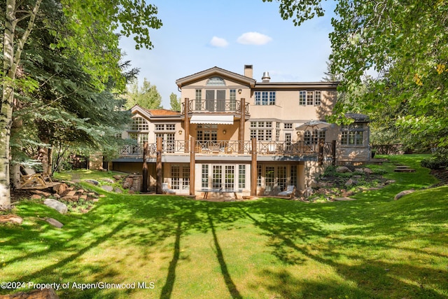 back of house with a lawn and a wooden deck