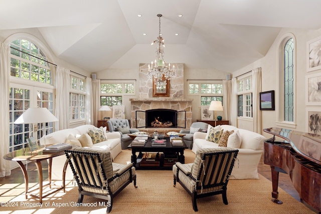 living room with a healthy amount of sunlight, lofted ceiling, and a fireplace