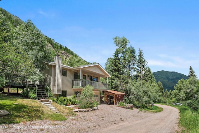 131 Aspen St, Redstone, CO 81623 - view of front of home with stairway, a mountain view, driveway, and a chimney
