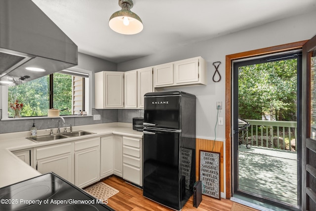 131 Aspen St, Redstone, CO 81623 - kitchen featuring freestanding refrigerator, light wood-style flooring, white cabinets, light countertops, and wainscoting