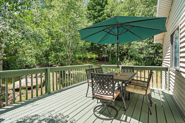 131 Aspen St, Redstone, CO 81623 - wooden terrace featuring outdoor dining space and view of scattered trees