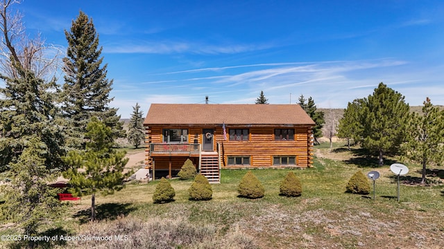 31 Ridge Dr, Craig, CO 81625 - rear view of house featuring log siding, stairway, a wooden deck, and a lawn
