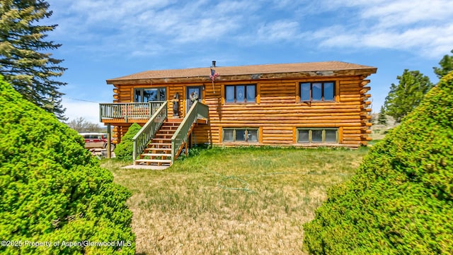 31 Ridge Dr, Craig, CO 81625 - rear view of property with log exterior, stairway, and a wooden deck